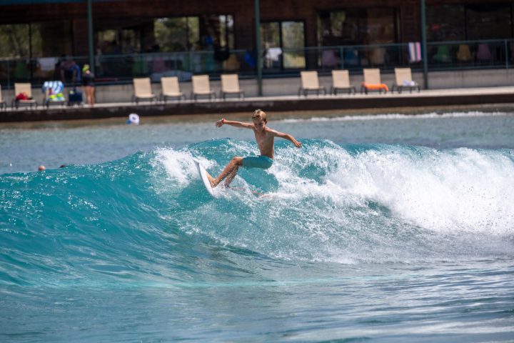 image of a young boy surfing riding a wave at waco surf a texas water park